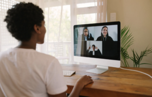 Woman setting up an interview with her subjects via Zoom